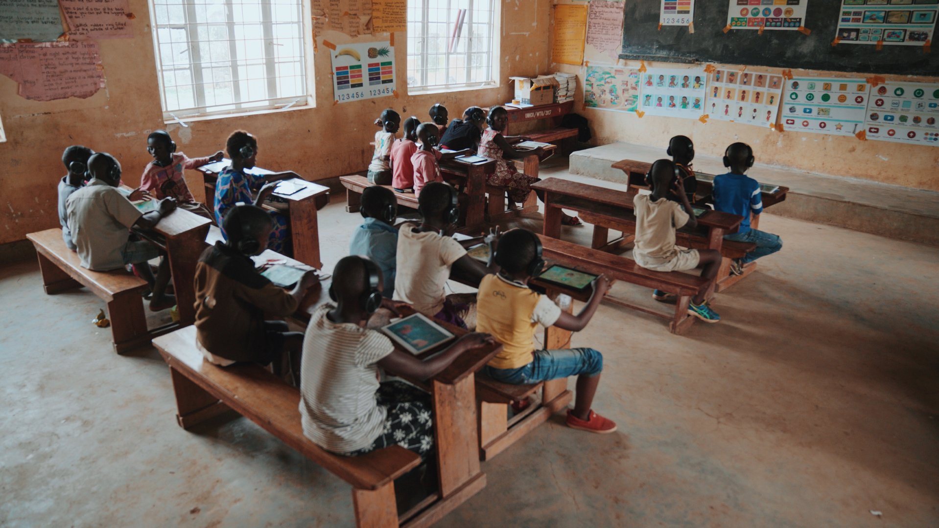 children learn with Can't Wait to Learn tablets from War Child