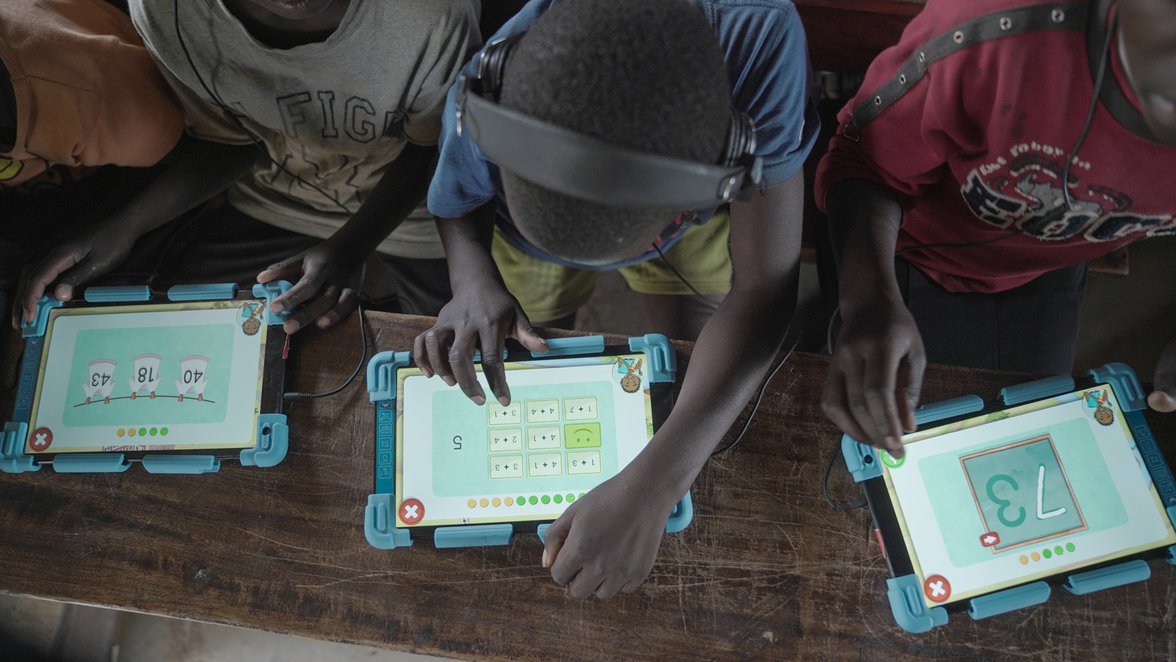 Children in school learning on tablets in Uganda with War Child's Can't Wait to Learn