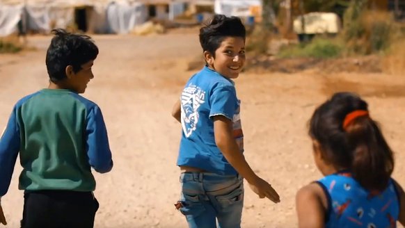 Boys and girl running in refugee camp in Lebanon - War Child