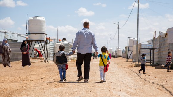 Father with kids in Jordan - refugee settlement - War Child programmes