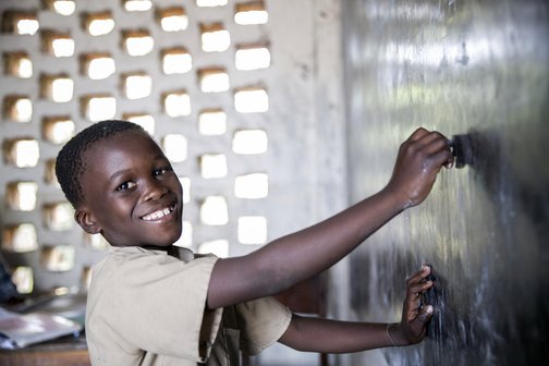 Jongen Burundi schoolbord schrijven recht op onderwijs War Child