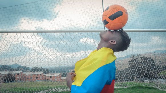 War Child Colombia Play it For Life participant balancing a football on his head